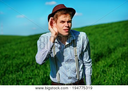 Handsome Man In The Nature Tries To Hear Something With Putting His Hand To His Ears