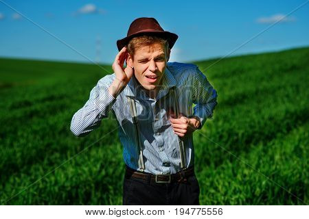 Handsome Man In The Nature Tries To Hear Something With Putting His Hand To His Ears