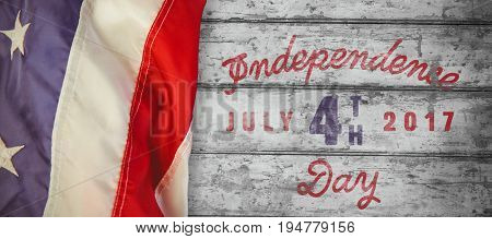 Digitally generated image of happy 4th of july message against wood background 