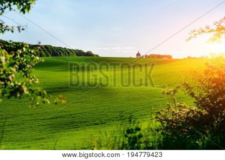 Morning Landscape With Green Field, Traces Of Tractor In Sun Rays