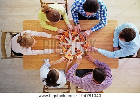People hands grabbing pizza from delivery box top view