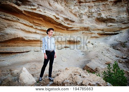 An Attractive Man Is Standing In The Middle Of A Sand Quarry And Looking Thoughtfully In The Distanc