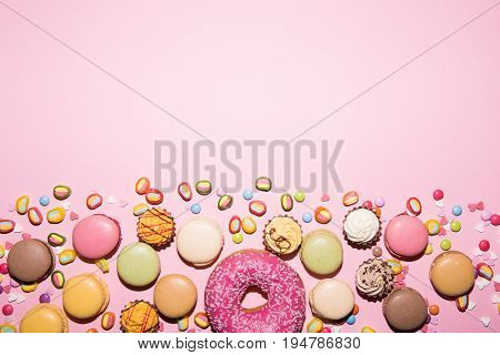 colofrul sweets, macarons, chokolade,candy on the pink background