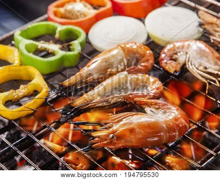 shripm prawns grilled on barbe cue stove fire with chilly and onion