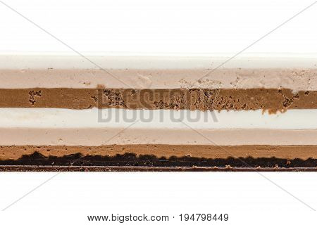 Three chocolates cake texture on white background. Cake of white milk and dark chocolate on crispy layer of chocolate brownie and dark chocolate