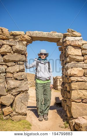 Tourist Exploring The Ancient Mysterious Inca Labyrinth-like Settlement, Called Chinkana, On The Isl