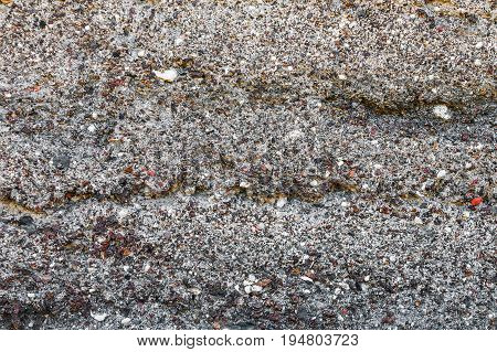Texture of a surface from a multicolored stone for use as a background. It consists of stones and slag.