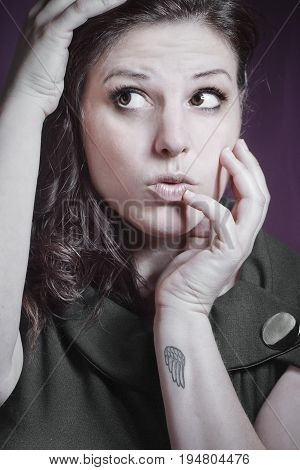 Portrait of a young woman with her head in her hands