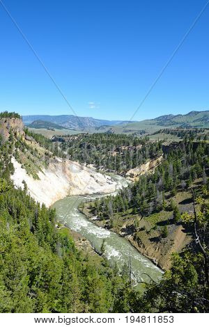 The Calcite Springs hydrothermal area is named for the milky-white calcite crystals that cover area. They are mixed with barite and yellow sulfur crystals.