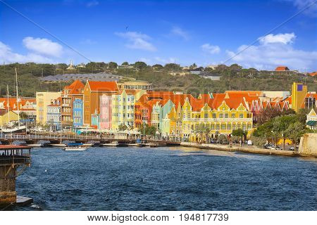 WILLEMSTAD, CURACAO - APRIL 18, 2017: Waterfront with colorful houses and seafront esplanade in Willemstad