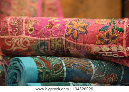 Colorful rugs pile flowers background pink light blue