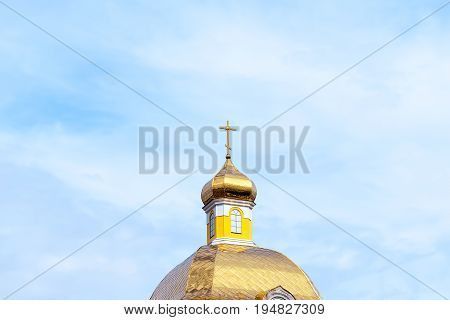Dome and cross against the blue sky