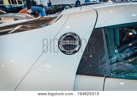 STUTTGART GERMANY - MARCH 17 2016: Fragment of a mid-engined plug-in hybrid sports car Porsche 918 Spyder 2015. The cover the charger connector. Europe's greatest classic car exhibition 