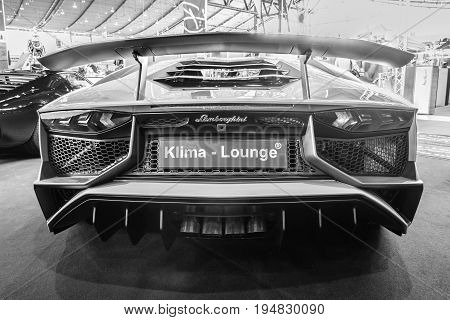 STUTTGART GERMANY - MARCH 17 2016: Mid-engined sports car Lamborghini Aventador LP 750-4 SuperVeloce 2016. Rear view. Black and white. Europe's greatest classic car exhibition 