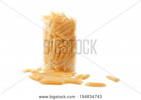 Many pasta in a transparent glass, isolated on a white background. Flour products. Raw pasta in a huge glass, isolated on a white background.