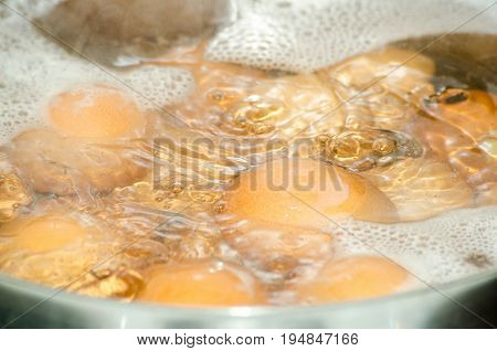 Cooking eggs. Close up. Selective focus. Boiling eggs in pot.