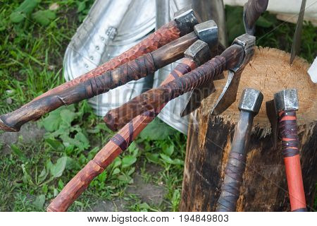 Several old battle axe stuck in the stump. Replica.