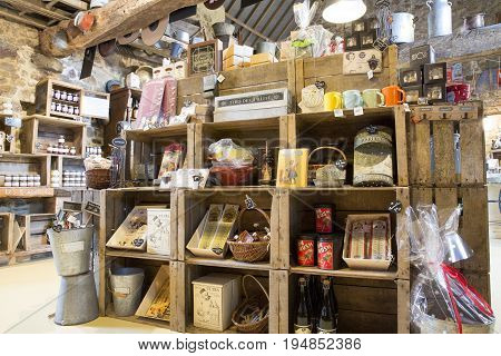Valognes Normandy France - February 06 2014. Traditional typical delicatessen shop in Normandy. Shop of jams chutney alcohol biscuits pasta beer milk jam and retro products for decoration In wooden boxes