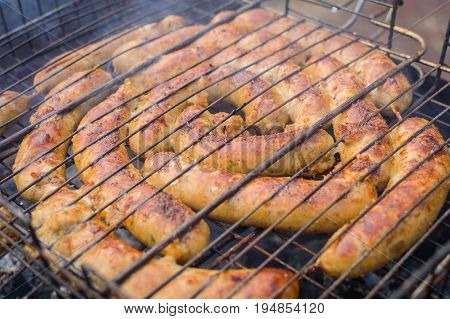 Grilling sausages on barbecue grill. Selective focus.