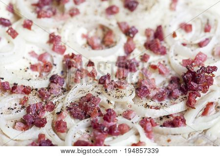 flammkuchen closeup with ham cubes and onions