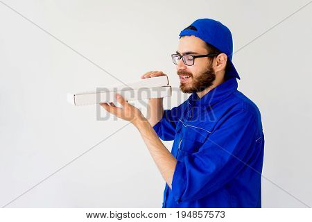 Pizza delivery service concept: delivery guy bringing pizza box