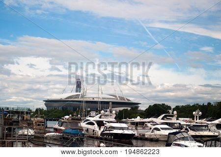Saint Petersburg Russia - July 08 2017: The new football stadium on Krestovsky island and the construction of a skyscraper Lahta-the centre . In the foreground of the yacht club.