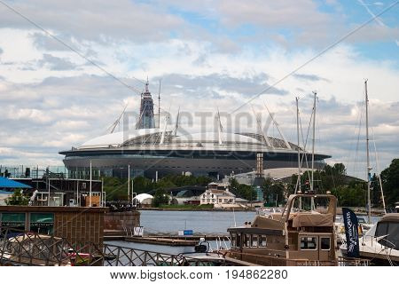 Saint Petersburg Russia - July 08 2017: The new football stadium on Krestovsky island and the construction of a skyscraper Lahta-the centre . In the foreground of the yacht club.