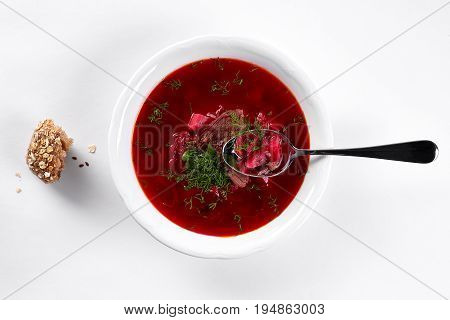 ukrainian soup borsch on white plate. Traditional ukrainian dish borsch isolated on white table, top view. first course