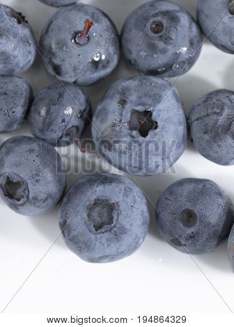 Multiple and Various Sized Blueberries on a White Background