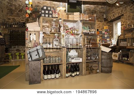 Valognes Normandy France - February 06 2014. Traditional typical delicatessen shop in Normandy. Shop of jams chutney alcohol biscuits pasta beer milk jam and retro products for decoration In wooden boxes