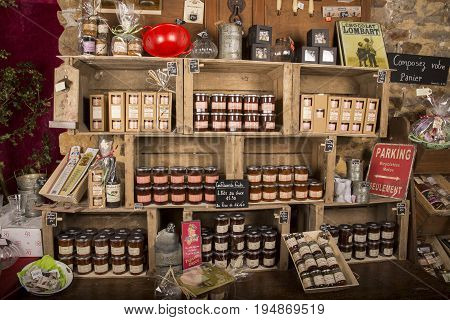 Valognes Normandy France - February 06 2014. Traditional typical delicatessen shop in Normandy. Shop of jams chutney alcohol biscuits pasta beer milk jam and retro products for decoration In wooden boxes