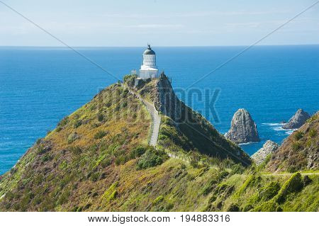 Lighthouse on Nugget Point. It is located in the Catlins area on the Southern Coast of New Zealand, Otago region. The Lighthouse is surrounded by small rock islands, nuggets