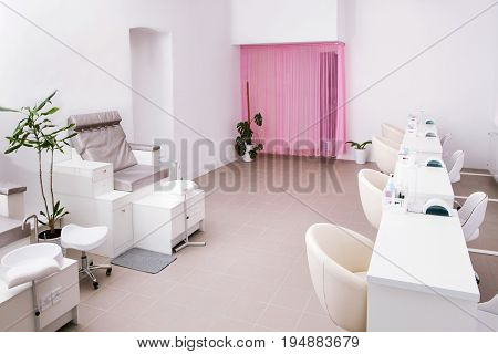 Interior of empty modern nail salon. Work places for masters of manicure