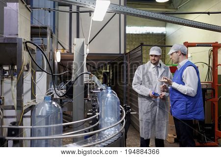 ST. PETERSBURG, RUSSIA - JUNE 29, 2017: Deputy director of St. Petersburg Quality Control Center Vladimir Barinov (left) talk with manager of the drinking water factory of Lider-Aqua  LTD