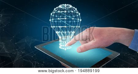 Croped hands of businessman using digital tablet against blue background with vignette
