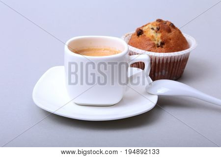 Classic espresso in white cup with homemade cake and chocolate on white background