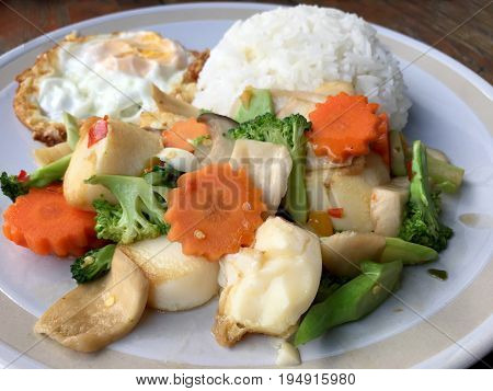 Mixed Fried Vegetable Tofu With Rice And Fried Egg In White Dish On Wooden Background. Vegetarian Fo