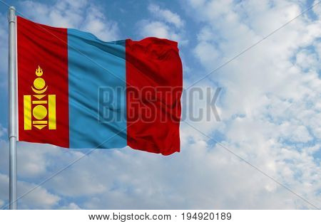 National flag of Mongolia on a flagpole in front of blue sky.