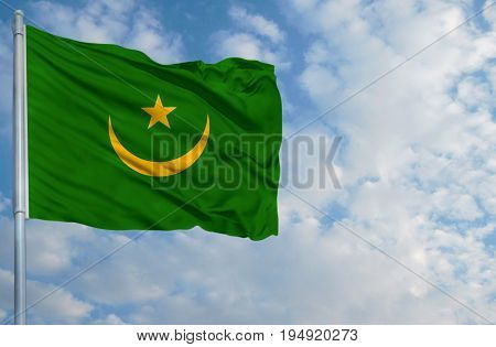 National flag of Mauritania on a flagpole in front of blue sky.