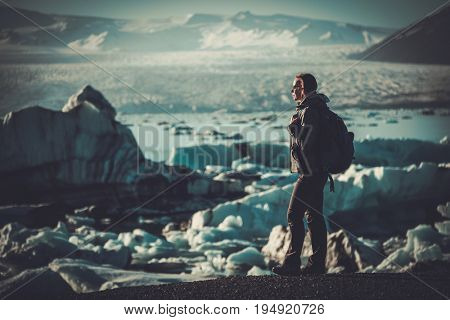 Woman explorer lookig at Jokulsarlon lagoon, Iceland.