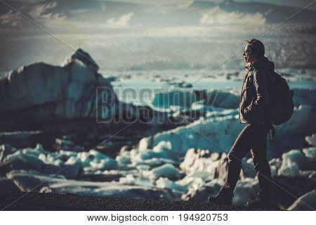 Woman explorer lookig at Jokulsarlon lagoon, Iceland.