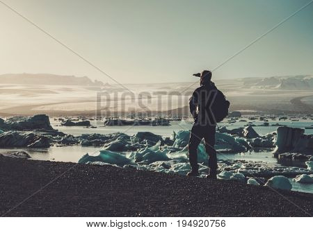 Man explorer lookig at Jokulsarlon lagoon, Iceland.