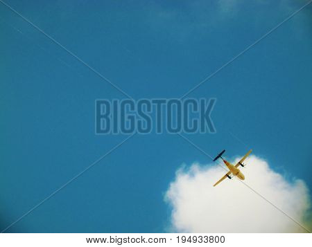 Plane over flying over St. Kitts with cloud