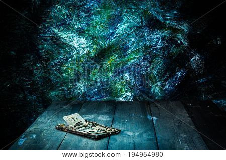 Still life style of old rattrap on wooden floor with colorfull backgroud