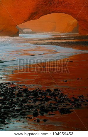 Legzira dramatic natural stone arches reaching over the sea, Atlantic Ocean, Morocco, Africa