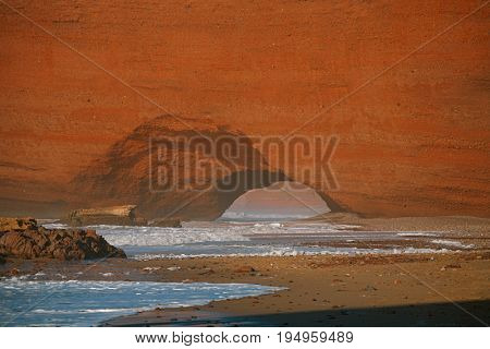 Legzira dramatic natural stone arches reaching over the sea, Atlantic Ocean, Morocco, Africa