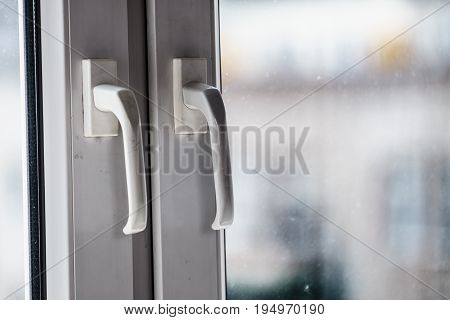Detailed close up of dirty window frame made of plastic and hadle.
