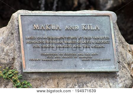 Honolulu Hawaii USA - May 28 2016:Makua and Kila plaque for the bronze sculpture along Waikiki Beach.
