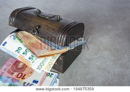 Euro banknotes stuffed in the vintage chest