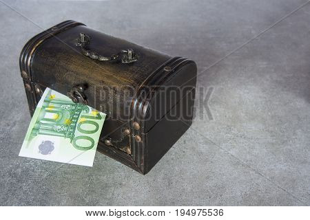 The half of hundred euro inserted in the chest box